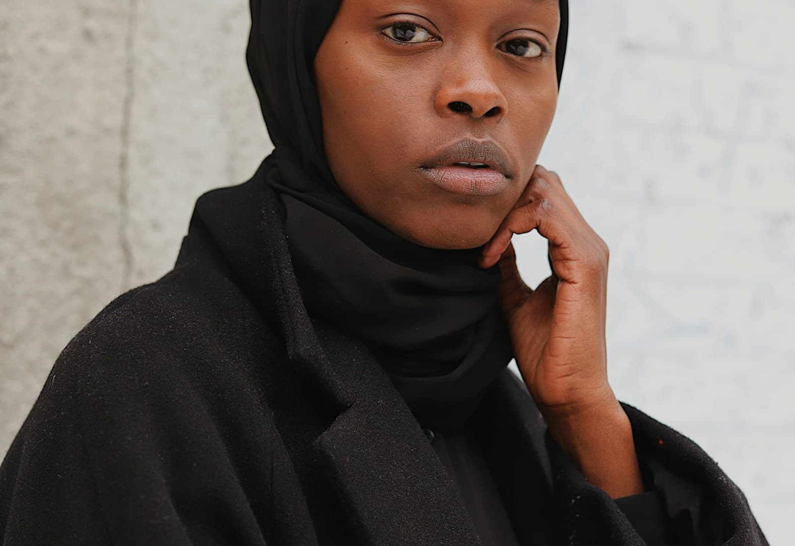 A refined black abaya and hijab portrait