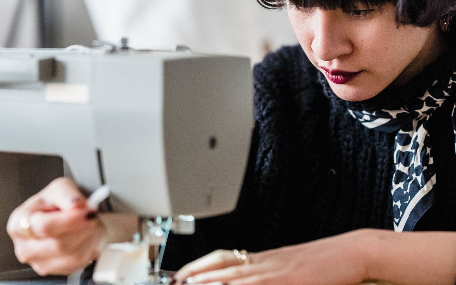 A seamstress shaping a new garment in her atelier
